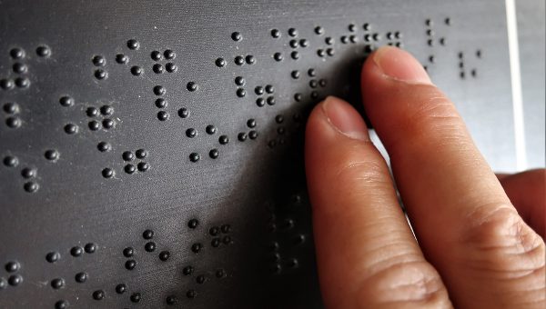 Detail čítania Braillovho písma. Zdroj: iStockphoto.com