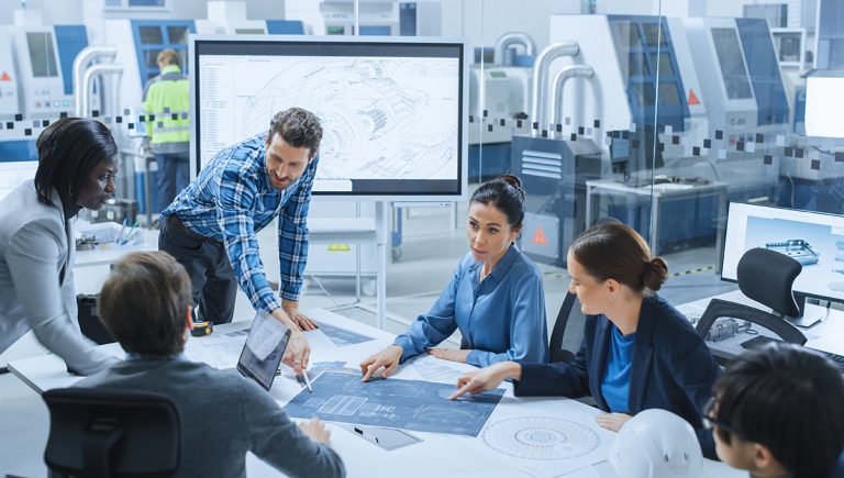 Diskutujúci kolegovia v modernej kancelárii továrne. Zdroj: iStockphoto.com