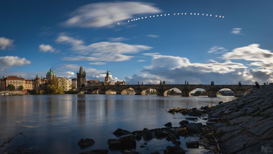 Čiastočné zatmenie Slnka nad Karlovým mostom v Prahe.